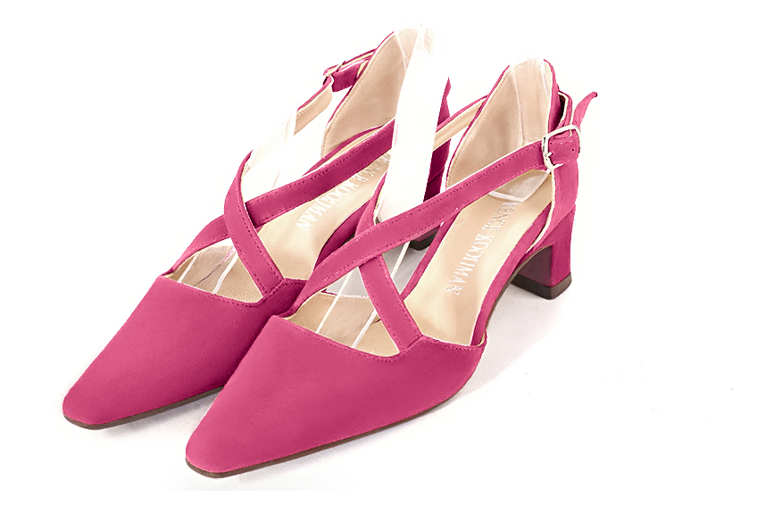 Fuschia pink women's open side shoes, with crossed straps. Tapered toe. Low kitten heels. Front view - Florence KOOIJMAN